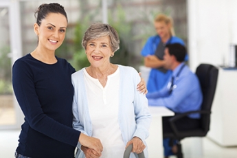 Stock photo of woman with an elderly patient in a medical setting