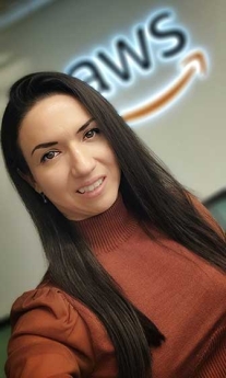 Sheyla Jafarova taking a selfie in front of the AWS logo