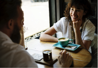 Photo of two people talking while having coffee