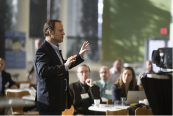 Photo of a business man talking to employees