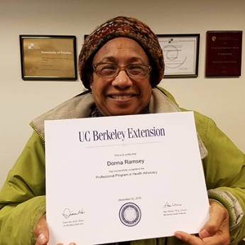 Donna Ramsey holds her Health Advocacy certificate