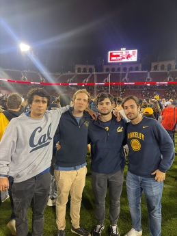 Eduardo Fatio and friends taking a photo on the football field at a Berkeley Cal game