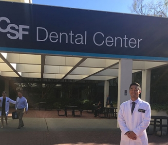 Kyle Takahashi stands outside of the UCSF Dental School