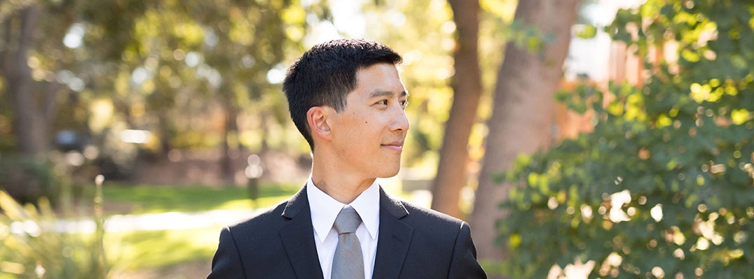 Certificate Program in Finance graduate Hosea Lin in a suit, looking off to the side