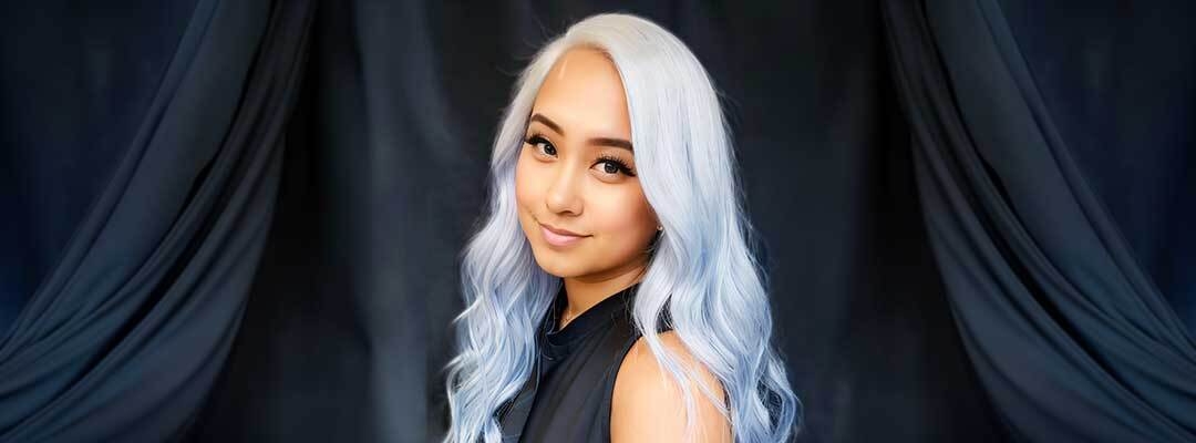 Headshot of MJ Aguillon in front of a dark blue background