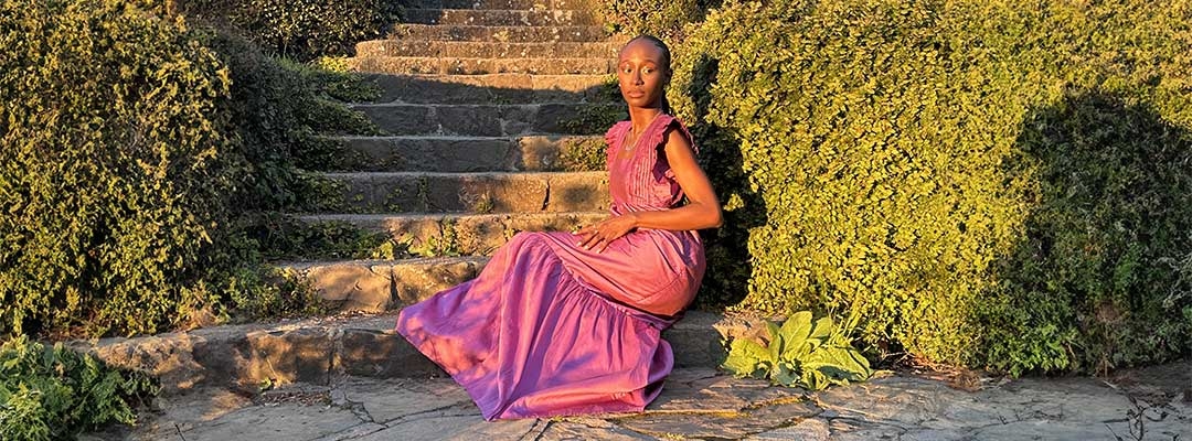 Mariane Iman Ndiaye posing while sitting on steps on Berkeley campus