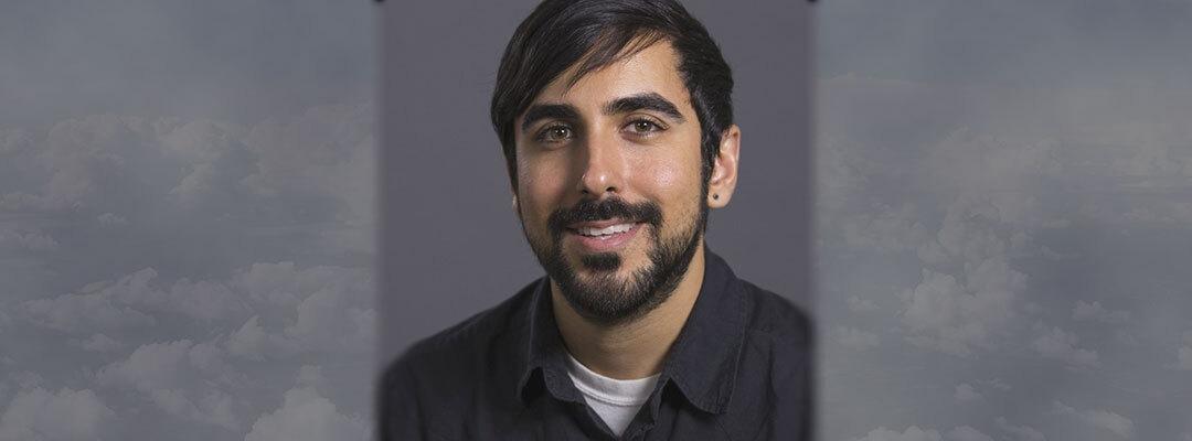 Photo of Ramin Partovi in front of a gray background