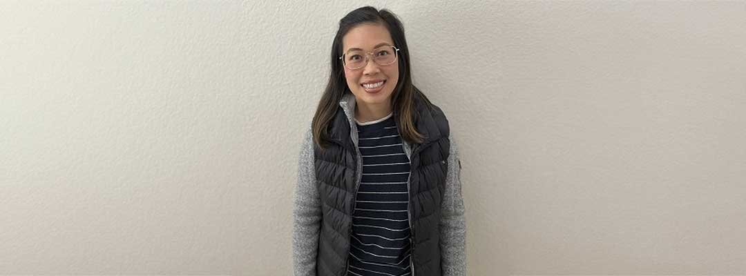 Vivian Dao Tong standing in front of white plastered wall