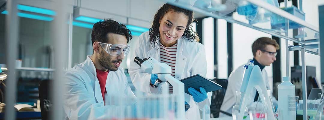 Diverse students working at a lab with microscopes