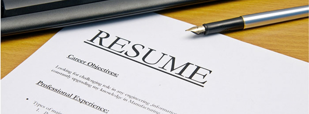 Stock photo of a pen, a keyboard and a paper resume showing career objectives