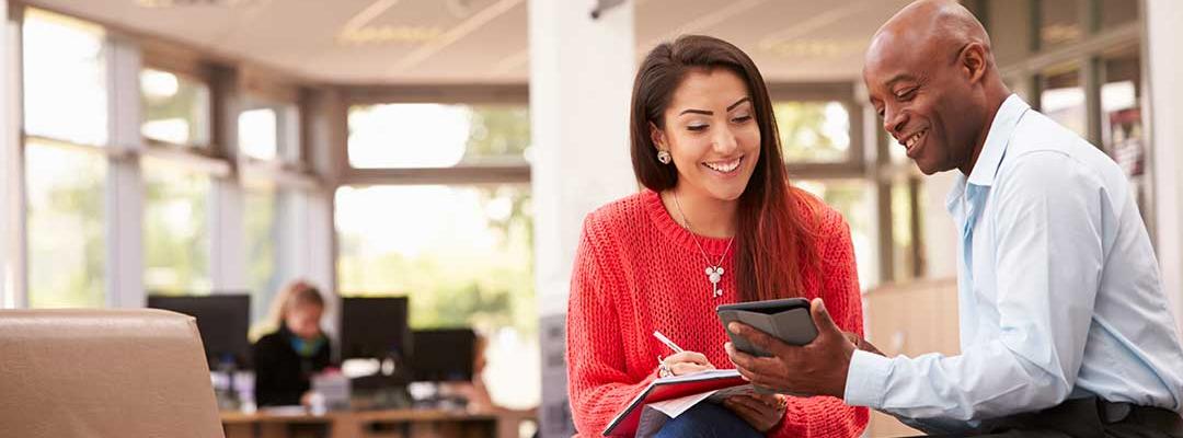 Photo of black college admissions adviser working with LatinX high school student