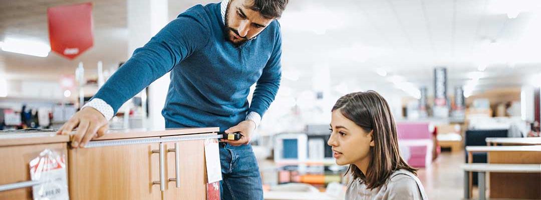 Photo of a couple shopping for school furniture