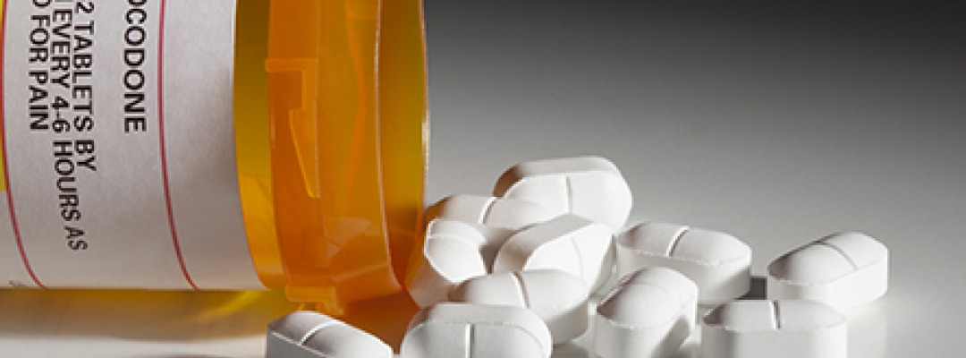 Photo of prescription opioids spilling out of bottle