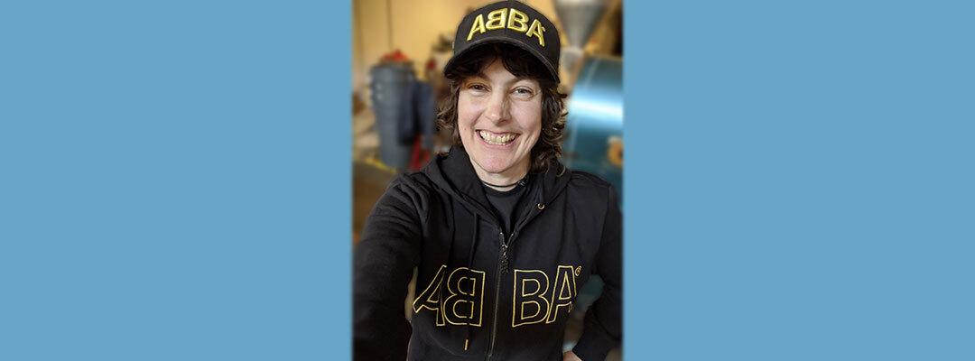 Photo of Jen St. Hilaire wearing ABBA sweatshirt and hat