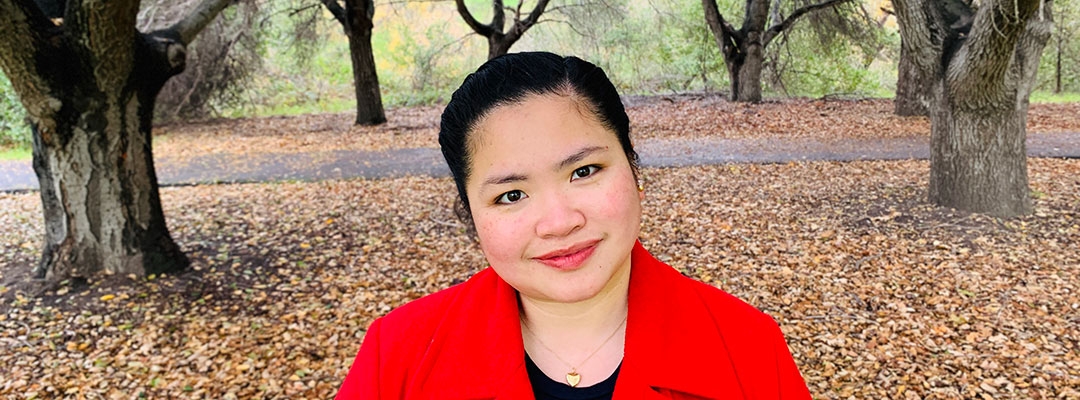 Project Management certificate graduate Laurice Gonzales outside under autumn trees