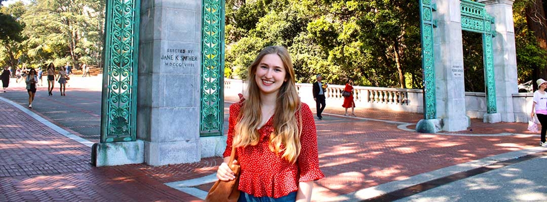 Lilly May standing in front of UC Berkeley Sather Gate