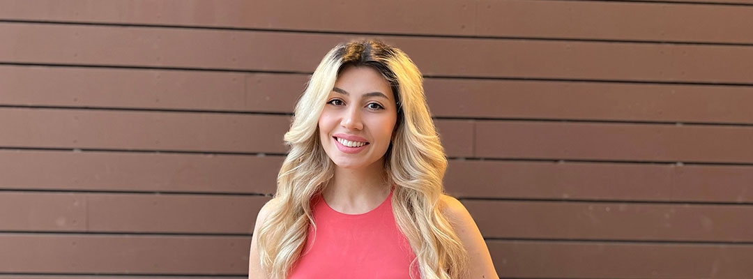 Certificate Program in Marketing graduate Marine Danielyan in front of painted brown wall