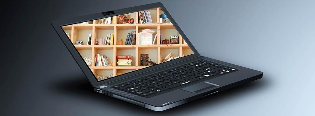 Stock photo of a black laptop open with a wooden bookcase filling the screen