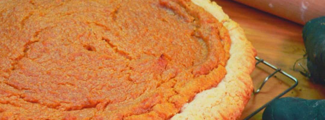 photo of a baked sweet potato pie resting on a cooling rack