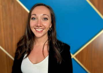 Headshot of Amanda Allen in front of a blue and wood background