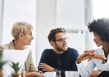 Photo of diverse group of professionals sitting at a table