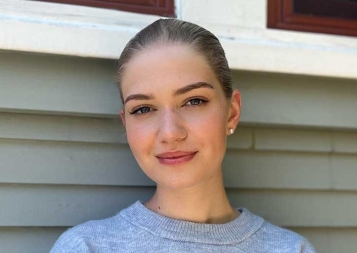 Photo of Greta Puschmann standing outside of a house