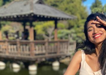 A girl standing in a Japanese tea garden