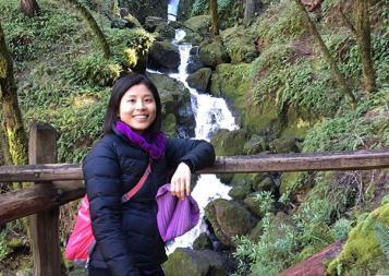 Interior designer Julia Chang posed in front of a waterfall