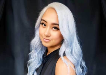 Headshot of MJ Aguillon in front of a dark blue background