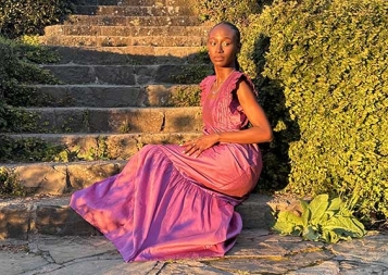 Mariane Iman Ndiaye posing while sitting on steps on Berkeley campus