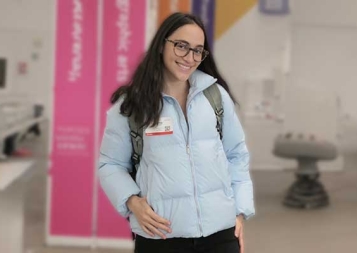 Photo of Marina Zalcberg Angulo standing in a graphic design room