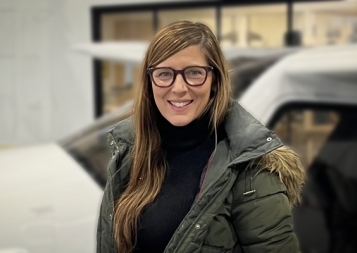 Professional Sequence in Editing graduate Megan Rupert, in front of small aircraft