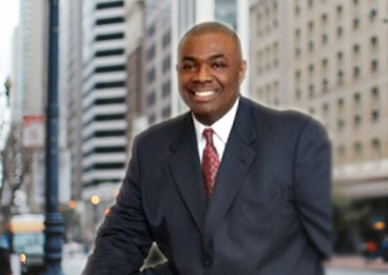 Headshot of Nathaniel Crews in front of San Francisco street and buildings