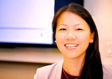 panelist siwei tang in front of a monitor display