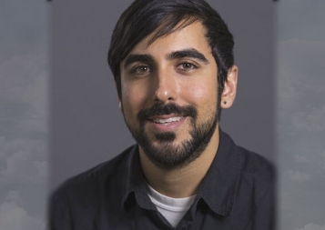 Photo of Ramin Partovi in front of a gray background