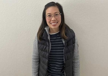 Vivian Dao Tong standing in front of white plastered wall