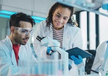 Diverse students working at a lab with microscopes