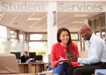 college adviser working with young student