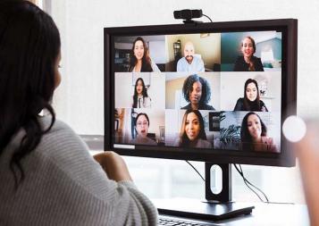 Black woman working from office on a teleconference call