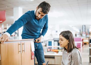 Photo of a couple shopping for school furniture