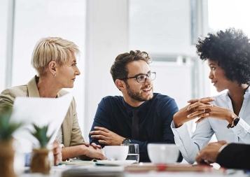 Photo of diverse group of professionals sitting at a table