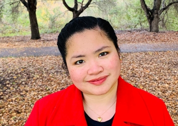 Project Management certificate graduate Laurice Gonzales outside under autumn trees