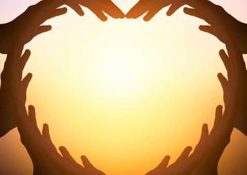 Illustration of hands joined together to shape a heart with sun in background