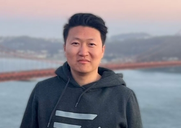 Photo of Michael Zhao standing in front of the Golden Gate Bridge