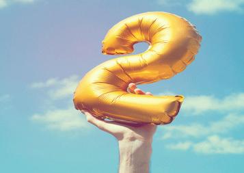 photo of hand holding a number 2 balloon