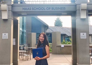 Photo of student Rioko Enomoto standing under Haas School of Business sign