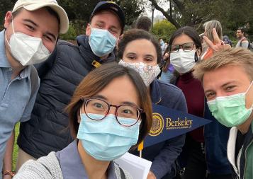 Group selfie of international students wearing masks on UC Berkeley campus 