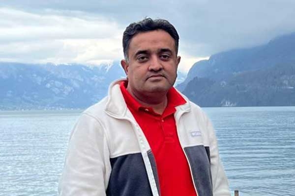 Photo of Himanshu Bhadra standing in front of a lake