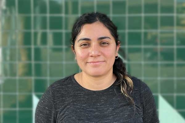 Photo of Lucía Moreno Nava in front of a green tile wall