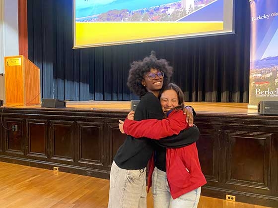 Mariane Iman Ndiaye and a friend share a hug at BGA closing ceremony